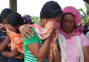 Women in Mindanao crying over their murdered relatives